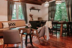 a living room with a couch and a table at Okno na las in Wola Polska