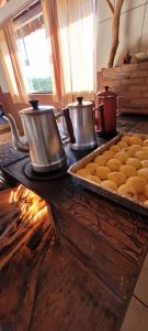 a kitchen with two pots and a tray of food at Pousada do Zezé in Bueno Brandão