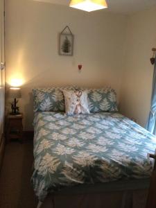 a bedroom with a bed with a teddy bear on it at Cosy Rural Cottage Peak District, Pets Welcome in Hollinsclough