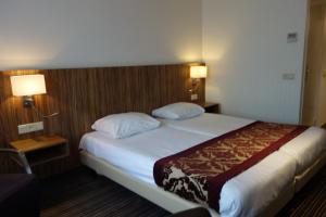Postel nebo postele na pokoji v ubytování Hotel Middelburg