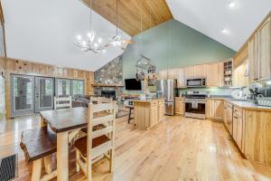 a large kitchen with wooden cabinets and a wooden table at Deer Run Retreat in Ellijay