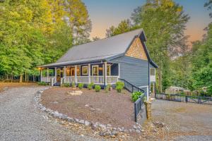 a home with a gambrel roof and a driveway at Deer Run Retreat in Ellijay