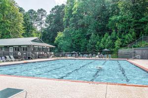 a large swimming pool with chairs and a house at Deer Run Retreat in Ellijay