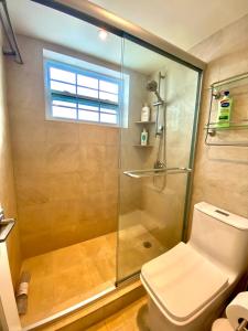 a bathroom with a glass shower with a toilet at Premium Modern waterfront apartment with Miami Skyline view on the bay 5 mins drive to Miami Beach with free parking in Miami Beach