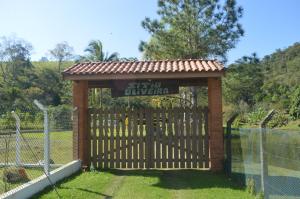 una puerta en una valla con una señal en ella en Sítio Oliveira en Itariri
