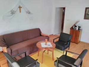 a living room with a couch and chairs and a table at Holiday house with a parking space Orolik, Slavonija - 14358 in Privlaka