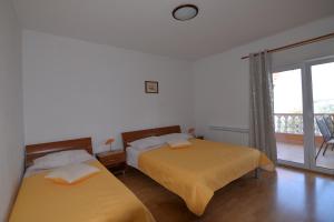 sypialnia z 2 łóżkami i balkonem w obiekcie Apartments by the sea Tkon, Pasman - 16589 w mieście Tkon