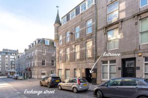 a group of cars parked in front of a building at Silver Stone Suite - in the heart of Aberdeen in Aberdeen