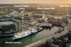 a large ship is docked in a harbor at Silver Stone Suite - in the heart of Aberdeen in Aberdeen