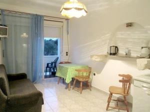a kitchen and living room with a table and a chair at Apartments for families with children Banjol, Rab - 16645 in Rab