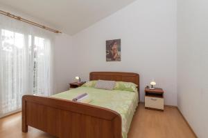 a bedroom with a large bed and two night stands at Apartments with parking space Slatine, Ciovo - 16732 in Slatine