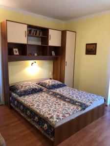 ein Schlafzimmer mit einem Bett mit Bücherregal darüber in der Unterkunft Apartment Barbat 16723b in Rab