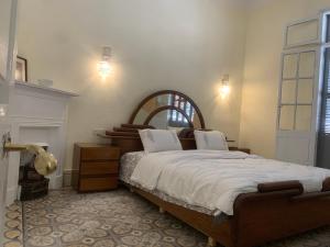a bedroom with a large bed and a fireplace at Dar Joury in Tangier