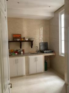 a kitchen with a counter with a laptop on it at Dar Joury in Tangier