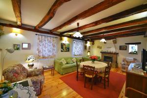a living room with a table and a couch at Holiday house with WiFi Paz, Central Istria - Sredisnja Istra - 16623 in Buzet +13 photos