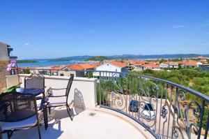 a balcony with chairs and a view of the ocean at Family-friendly apartments with swimming pool Murter - 16655 in Murter