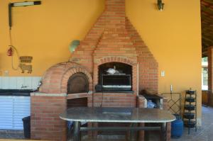 a brick oven with a table in front of it at Sítio Oliveira in Itariri