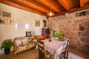 a living room with a table and a couch at Holiday house with a parking space Gornja Podgora, Makarska - 16835 in Podgora +9 photos