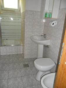 a bathroom with a toilet and a sink at Apartments by the sea Sevid, Trogir - 16855 in Marina