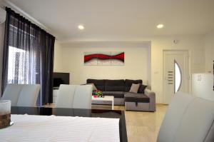 a living room with a couch and a table at Apartment Tribunj 16884b in Tribunj