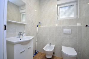 a bathroom with a sink and a toilet at Apartment Tribunj 16884b in Tribunj +10 photos