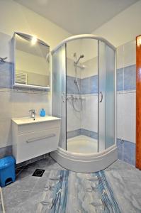 a bathroom with a shower and a sink at Apartments by the sea Podstrana, Split - 16829 in Podstrana