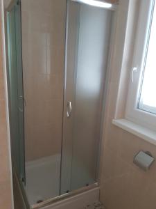 a shower with a glass door in a bathroom at Studio Novi Vinodolski 16998a in Novi Vinodolski
