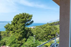 a view of the ocean from the balcony of a house at Apartments with a parking space Brela, Makarska - 16596 in Brela