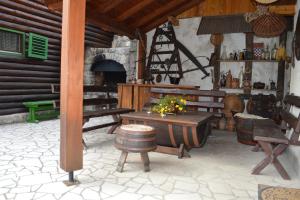 a patio with benches and a table and a fireplace at Rooms with a parking space Brod Moravice, Gorski kotar - 16921 in Brod Moravice