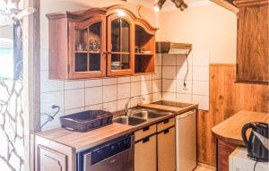 a small kitchen with a sink and a stove at Gorgeous Apartment In Retowo 4 With Kitchen in Gardna Wielka