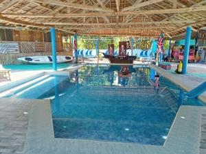 a large swimming pool with a water park at Happy bear moalboal budget rooms in Moalboal