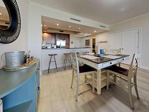 a kitchen and dining room with a table and chairs at La Salbadora #402C at Lost Key in Perdido Key