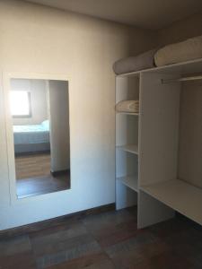 a room with a mirror and a bedroom with a bed at Las Casitas y Los Duplex de Chacras de Coria in Chacras de Coria