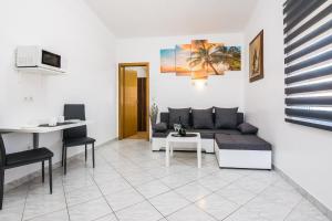 a living room with a couch and a table at Apartments with parking space Vir - 18540 in Vir