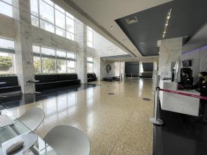 a large room with tables and chairs in a building at Flat Lider Brasilia in Brasilia