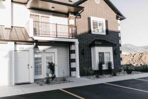 a brick house with white doors in a parking lot at NEW CONDO Cache Valley 3BR 2BA - Sleeps 7 in Logan