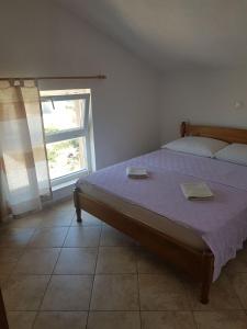 1 dormitorio con 1 cama con 2 toallas en Apartments by the sea Sevid, Trogir - 16802, en Marina