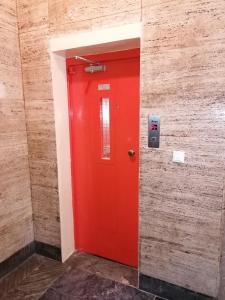 a red door in the corner of a brick wall at Galeb in Rijeka