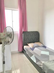 a bedroom with a bed with a fan and a window at PalamStay in Kuala Selangor +14 photos