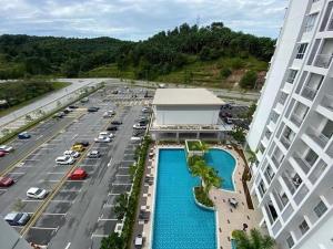 an aerial view of a parking lot with a pool at PalamStay in Kuala Selangor