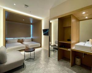 a bathroom with two beds and a sink at Harper Boutique Hotel at Sutera Avenue in Kota Kinabalu