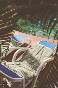 a couple of beds sitting on a porch at Club Tropical Resort - Newly renovated Studio Apartments in Port Douglas