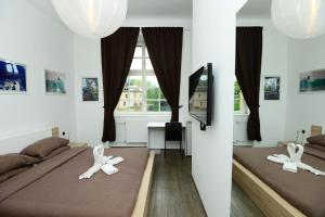 a hotel room with two beds and two lamps at Galeria Rooms in Ljubljana
