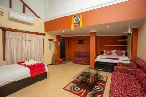 a hotel room with a bed and a couch at Kathmandu Boutique Hotel in Kathmandu