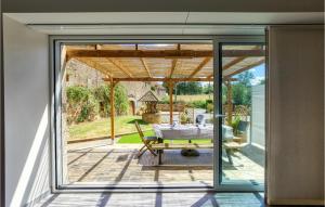 a glass extension to a house with a patio at Lovely Home In Baraqueville With Kitchen in Baraqueville