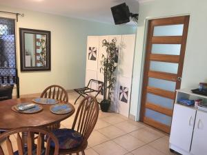 a kitchen and dining room with a table and chairs at Palmerston Sunset Retreat in Palmerston