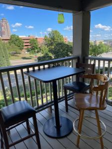 a table and chairs on a balcony with a view at Sherman Hill Des Moines in Des Moines