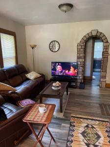a living room with a couch and a flat screen tv at Sherman Hill Des Moines in Des Moines