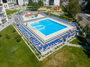 an overhead view of a large swimming pool with chairs and a water park at Zem-Tourist in Pustkowo
