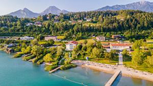 an aerial view of a town next to a river at Strandhotel Faak in Faak am See